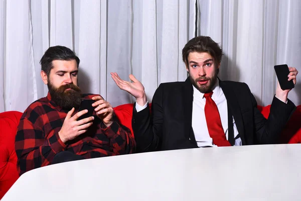 bearded men, surprised businessmen with mobile or cell phone