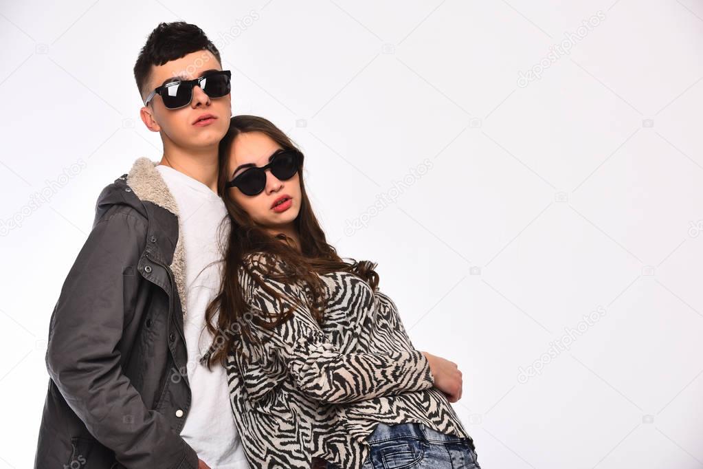 couple of pretty girl and young guy in fashionable sunglasses