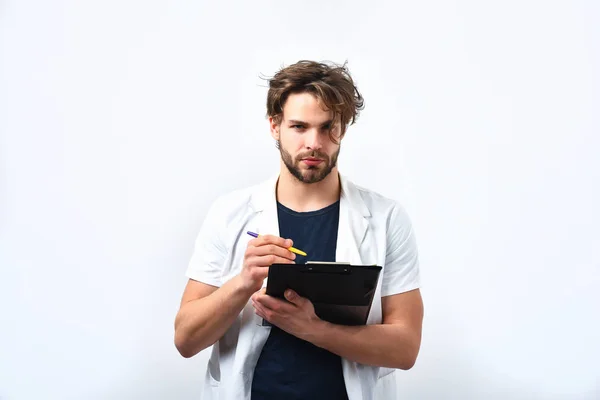 Bearded caucasian doctor or postgraduate student with clipboard and pen — Stock Photo, Image