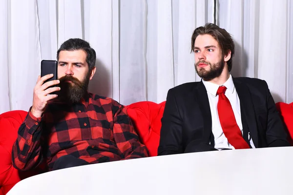bearded men, serious businessmen with mobile or cell phone