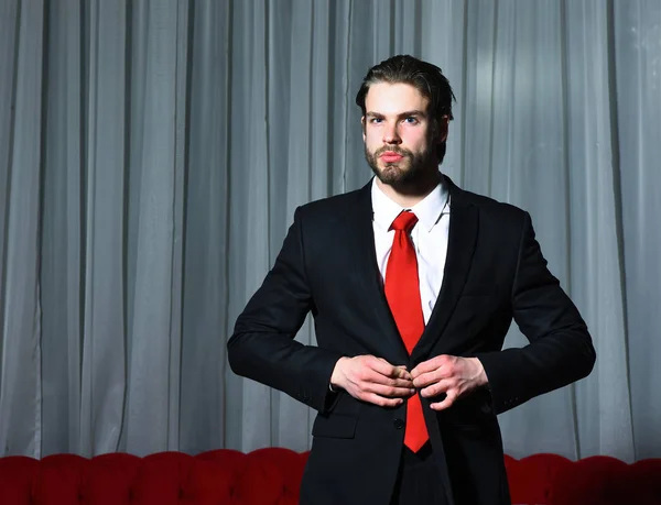 Hombre barbudo, hombre de negocios en traje y corbata roja contra cortinas —  Fotos de Stock