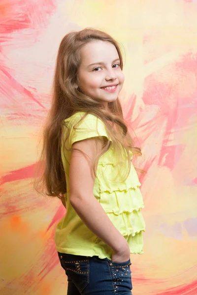 Pequena menina com rosto feliz na camisa amarela — Fotografia de Stock