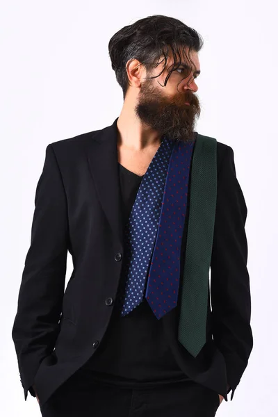 Brutal caucasian hipster in black suit with ties on shoulder — Stock Photo, Image