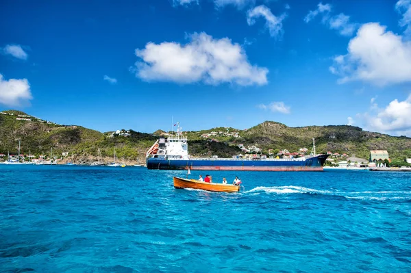 People in boat, big cargo ship, French island, St. Barts — Stock Photo, Image