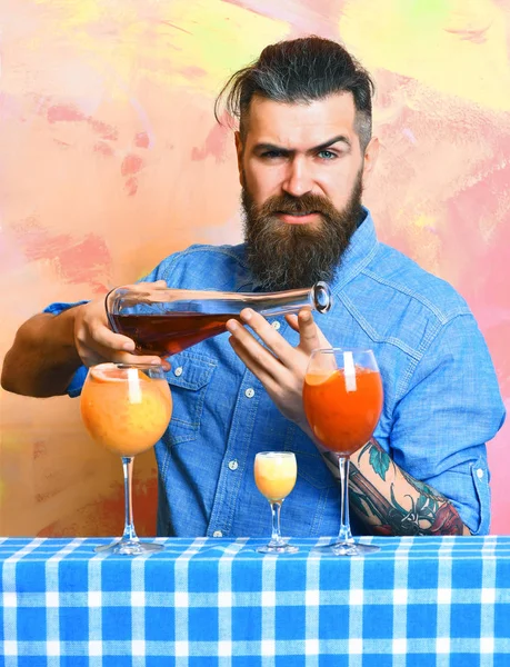 Brutal caucasian hipster with alcoholic cocktails and bar stuff