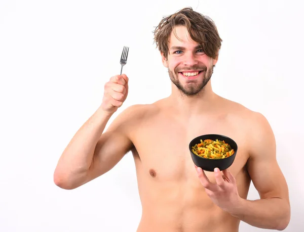 Caucasian sexy young macho holding black bowl with pasta — Stock Photo, Image