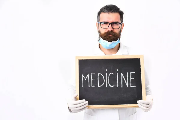 Бородатый кавказский врач со шприцем и доской с медицинской надписью — стоковое фото