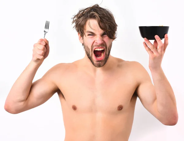 Caucasian sexy young macho holding black bowl with fork — Stock Photo, Image