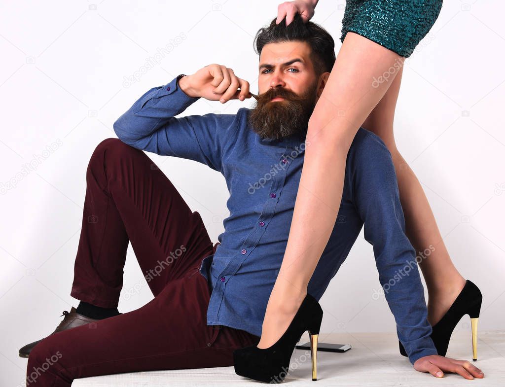 bearded man with sexy female legs has serious face