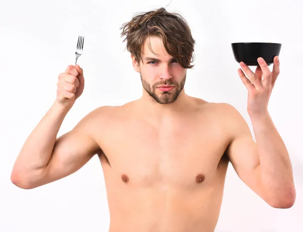 Caucasian sexy young macho holding black bowl with fork — Stock Photo, Image