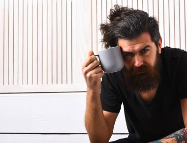 Kafkasyalı vahşi bir hippi elinde bardak ya da kupa tutuyor.