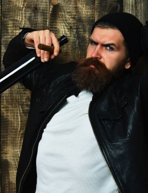 Sakallı, Kafkas hippisi elinde şişe, puro içiyor.