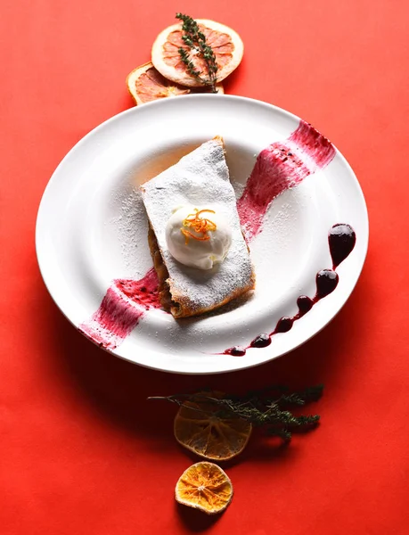 Delicious apple strudel with vanilla ice cream and berry sauce — Stock Photo, Image