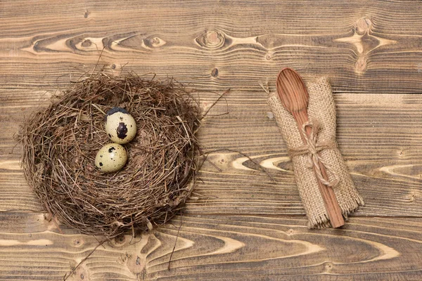 Quail eggs in nest with wooden spoon in burlap, easter — Stock Photo, Image