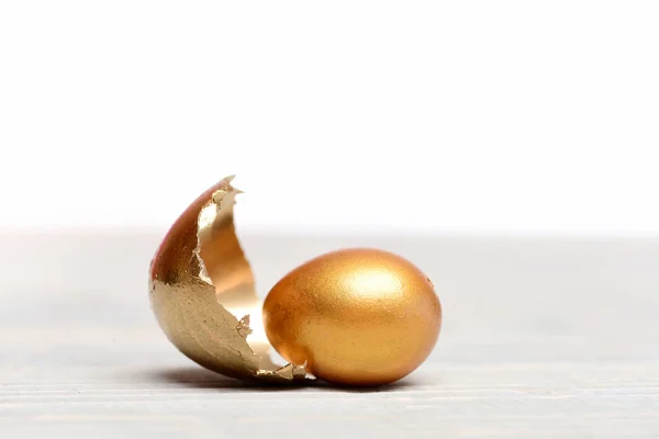 broken easter golden egg shell, future life, luxury and success
