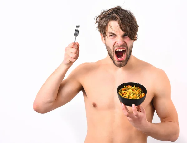 Caucasian sexy young macho holding black bowl with pasta — Stock Photo, Image