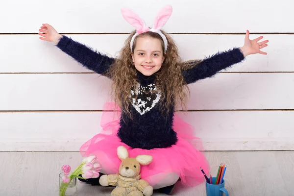 happy girl with easter rabbit toy, pencil, tulip flowers