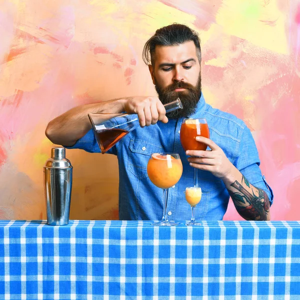 Brutal caucasian hipster with alcoholic cocktails and bar stuff