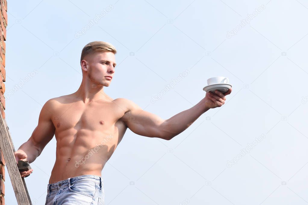 man holding cup of coffee on sky background, serious face