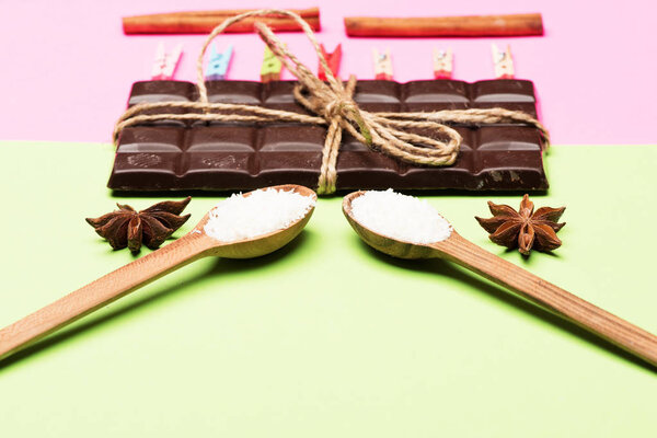 Milk chocolate on pink and green background