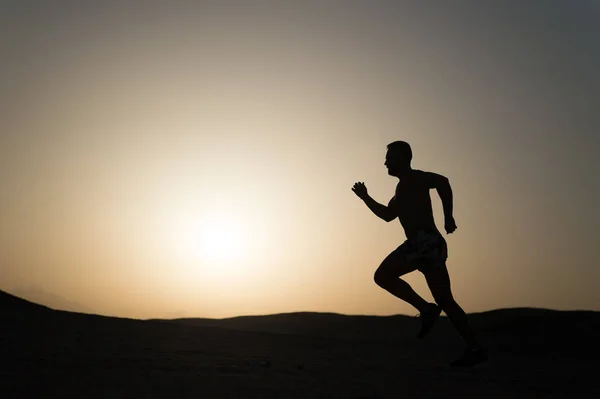 Silhouette or man runner, guy running outdoor at clear sky — Stock Photo, Image