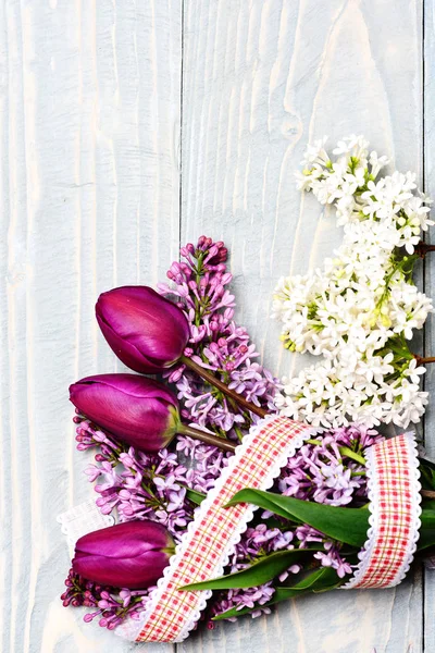Ramo envuelto en cinta a cuadros de flores lila con tulipanes — Foto de Stock