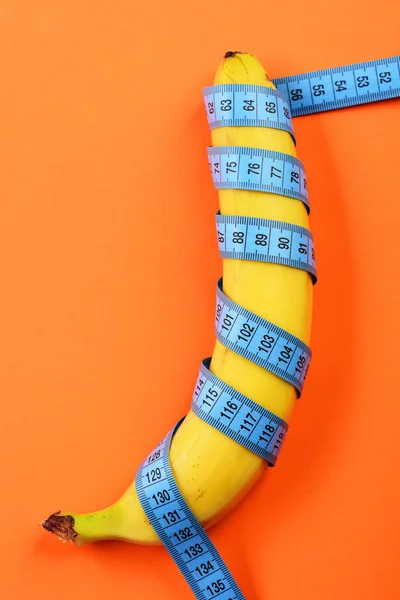 Measure tape on yellow banana