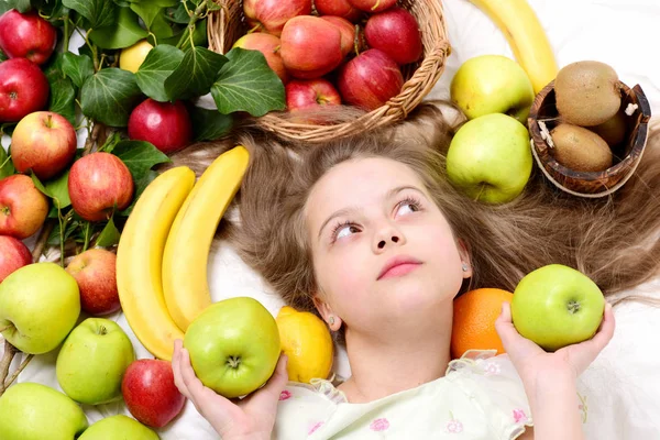 Little happy girl or cute hungry child eating colorful fruit — Stock Photo, Image