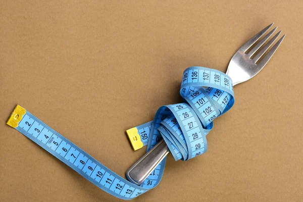 Tejp för att mäta wraps runt metall gaffel — Stockfoto