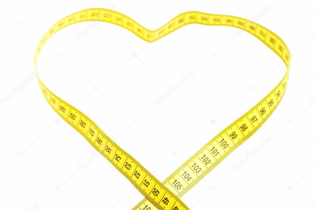 yellow measuring tape in heart shaped isolated on white
