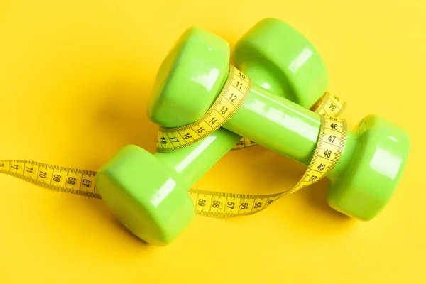 Ideal size. Dumbbells in green color with measuring tape