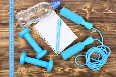 Spor programı kavramı ile defter, atlama ipi ve halter