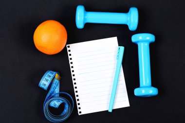 Turuncu meyve, sayfa ve kalem ile beslenme ve spor kavramı