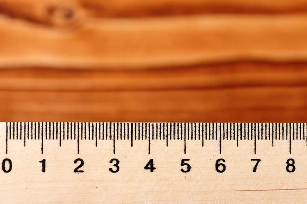 Ruler on vintage wooden background, concept of geometry, school, — Stock Photo, Image