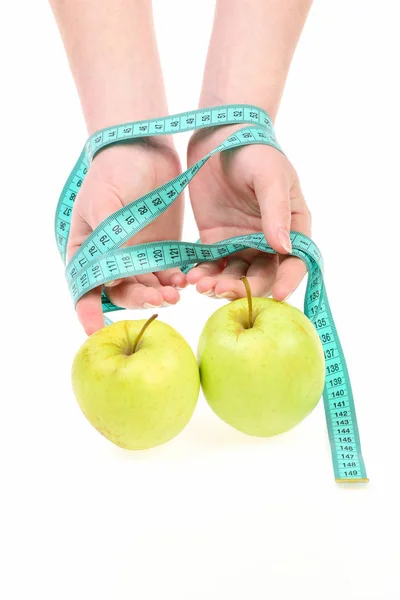 Hands of woman wrapped around with measuring tape and apples Stock Image
