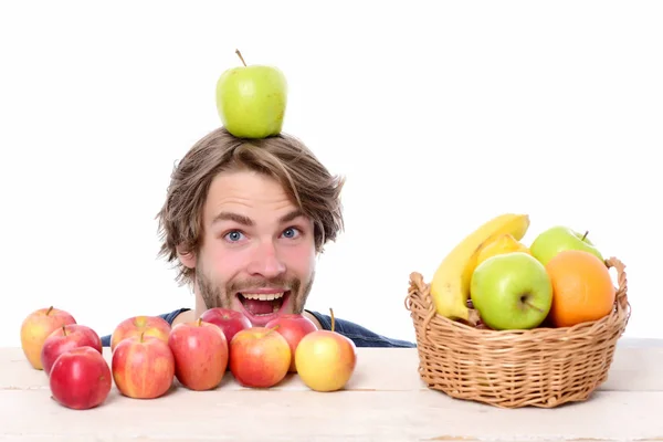 Hombre feliz sorprendido con manzana en la cabeza y manzanas rojas — Foto de Stock