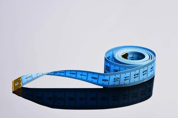 Roll of blue flexible ruler on grey surface — Stock Photo, Image