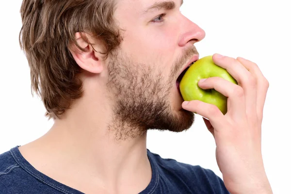 Cara com barba mordendo maçã verde isolado em branco — Fotografia de Stock