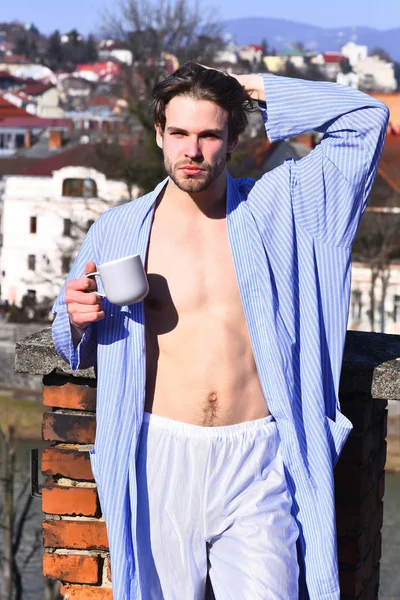 Caucásico macho en azul rayas pijama celebración taza — Foto de Stock