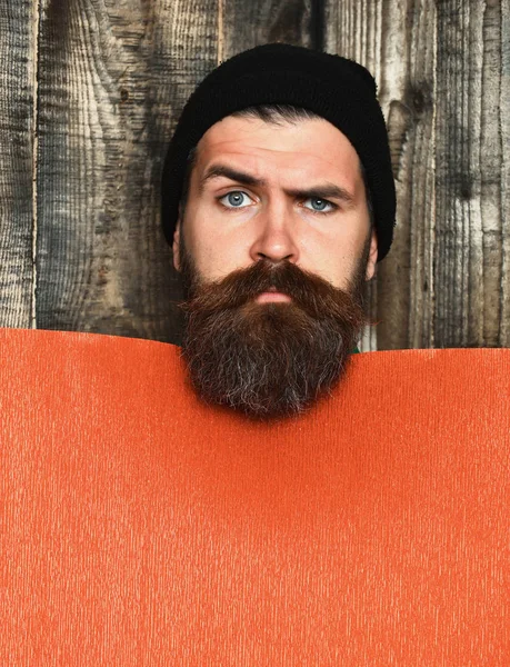 Skäggig brutal kaukasisk hipster med rött pappersark — Stockfoto