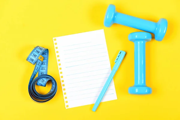 Copy space on page with blue pen, dumbbells and tape — Stock Photo, Image