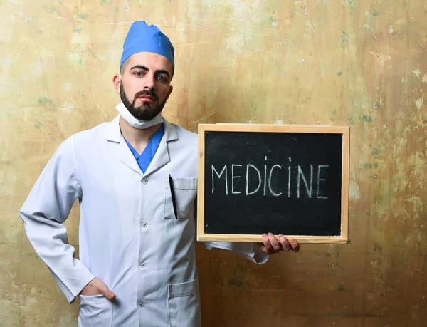 Cara de uniforme médico segura quadro negro com palavra medicina — Fotografia de Stock