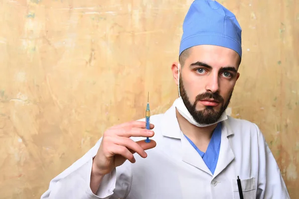Medic syringe in hand of bearded doctor — Stock Photo, Image