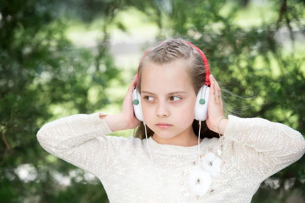 Cute little girl enjoying music using headphones — Stock Photo, Image