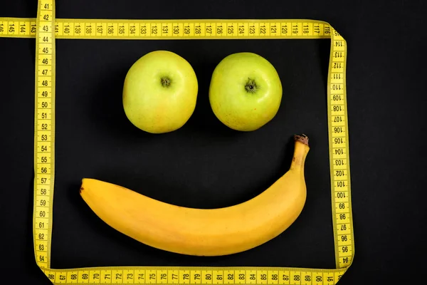 Smiley with happy expression made of banana and apples