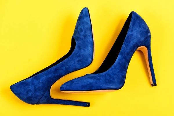 High heel footwear isolated on yellow background. Shoes in blue — Stock Photo, Image