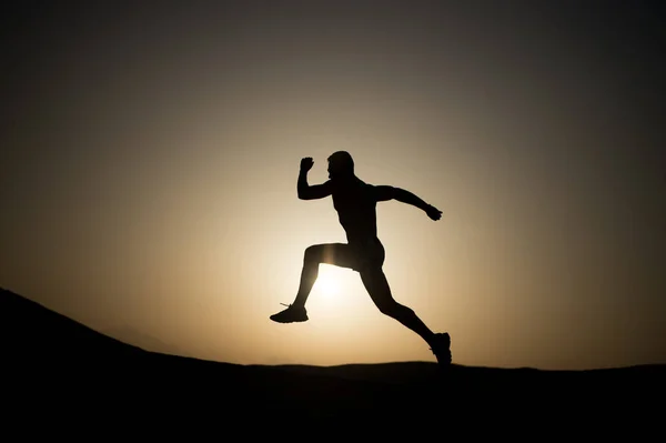 Silhouette or man runner, guy running outdoor at clear sky — Stock Photo, Image