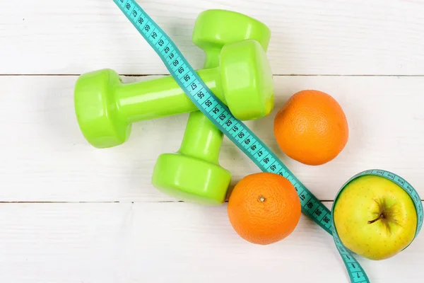 Apple, orange with measuring tape, weight dumbbells for diet concept — Stock Photo, Image