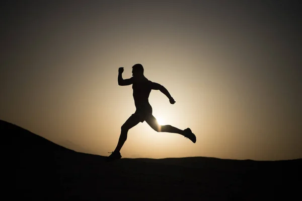 Running man silhouette at sunset sky — Stock Photo, Image