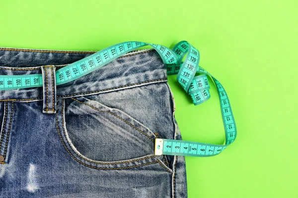 Close up de jeans com fita métrica em torno da cintura — Fotografia de Stock